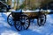 A historic cart with a blanket of snow