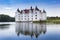 Historic castle with reflection in the lake in Glucksburg