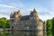 Historic Chateau Trecesson castle in the Broceliande Forest with reflections in the pond