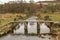 The historic Clapper Bridge made out of granite and crossing the East Dart River on Dartmoor National Park, England