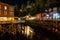 Historic Creek Street illuminated at night near the water in Ketchikan, Alaska