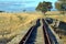 Historic disused railroad tracks through fields