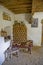 Historic farmhouse interior in a museum with an old tiled stove in the corner