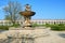 Historic fountain and long white colonnade