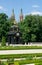 A historic gazebo decorated with sculptures, gold Griffin sculpture on the roof in the gardens of the Branicki Palace.