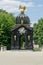 A historic gazebo decorated with sculptures, gold Griffin sculpture on the roof  in the gardens of the Branicki Palace,