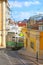 Historic green tram against old town streets, part of the tramway network since 1873, Lisbon, capital city of Portugal