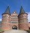 Historic Holstentor or Holsten gate of Lubeck in Germany, famous medieval landmark in red brick architecture, inscription