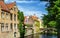 Historic houses with the city flag of Bruges, Belgium