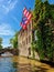 Historic houses with the city flag of Bruges, Belgium