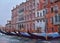 Historic houses of the Grand Canal in Venice. The beautiful facade of the Venetian palace. Blue gundoliers are moored to the