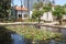 Historic houses and a water lily pond in the restored Sarona quarter of Tel Aviv