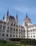 The historic hungarian Parliament building in Budapest with domes spires and blue sky