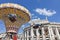 The historic Imperial Court Theatre at the famous Viennese Ringstrasse with some people enjoy a ride