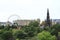 Historic landmark, Scott Monument in the heart of Edinburgh, Scotland with Ferris wheel at annual Fringe Festival