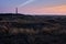 Historic lighthouse of Hollum with light beam, Ameland with a red and orange sky during sunset, sunrise. Dark dunes with