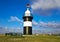 The historic lighthouse Kleiner PreuÃŸe with shrimp boats in the little habor of Wremen near Cuxhaven, Germany