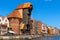 Historic medieval port crane - water gate - surrounded by Hanseatic houses at Motlawa river embankment in old town city center in