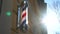 Historic old fashioned antique barber pole in a small town business barber shop. Barber shop vintage pole retro.