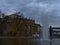 Historic opera house, venue of Staatsoper Stuttgart, with small lake Eckensee and tall fountain in evening.