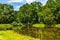 Historic park surrounding XVI century Rozalin Palace with vintage trees and ponds in Rozalin village in Mazovia region of Poland