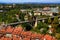 Historic part of Bern with red-roofed houses, green parks and iron arched bridge with mountains in the background