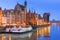 Historic port crane over Motlawa river in Gdansk at night