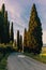 An historic public road in the hills of the Val d\\\'Orcia in Tuscany with a rusty guardrail