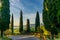 An historic public road in the hills of the Val d\\\'Orcia in Tuscany with a rusty guardrail