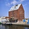 Historic red brick storage silo with quay and ship in the port of the Polish city of KoÅ‚obrzeg