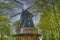 Historic and restored windmill in Berlin, Germany, between birch trees