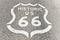 Historic Route 66 sign painted on asphalt of highway in Arizona - California