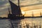 Historic sailboats in the rays of the setting sun