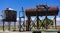 Historic steam railroad tanks for water and fuel in an old narrow gauge train yard in Laws, California