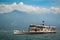 Historic steamboat packed with tourists approaching Limone Sul Garda at the shores of Lake Garda