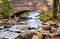 historic stone bridge on footpath around pond