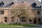 Historic stone building with gothic windows on the campus at Magdalen College, University of Oxford, UK.