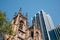 Historic stone gothic revival church building of St Andrew`s Cathedral next to urban high-rise towers in CBD.