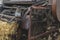 Historic straw press following a threshing machine in operation. The wheel turns and shows motion blur