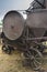 Historic straw press following a threshing machine in operation. The wheel turns and shows motion blur