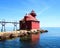 Historic sturgion bay Wisconsin lighthouse beautiful bright blue water and sky calm peaceful water wth reflection on water