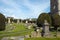Historic tombs and yew trees in the churchyard at Painswick