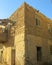 Historic townhouse building in the center of the ancient city of Quseir in Egypt. Walls of the house built of yellow sandstone.
