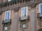 Historic townhouse windows with reflections