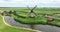 Historic traditional typical dutch old windmills mills on the rural countryside in green nature grass field farm