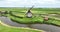 Historic traditional typical dutch old windmills mills on the rural countryside in green nature grass field farm