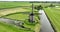 Historic traditional typical dutch old windmills mills on the rural countryside in green nature grass field farm
