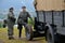 Historic truck with two men dressed in german nazi uniforms during historical reenactment of World War 2 battle