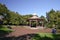 Historic Victorian wood gazebo with metal onion-shaped roof, and grass and trees in Albert Park, Auckland CBD, New Zealand