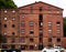 Historic weathered brick building with a warehouse and the production facilities for Danish pipe tobacco
